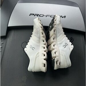 On men’s white sneakers.